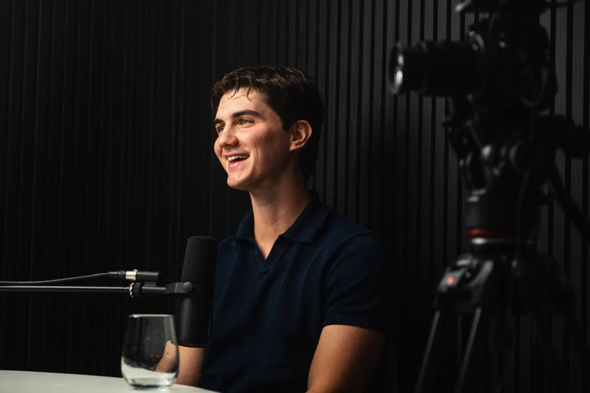 Nick Mihailou smiling during a studio recording